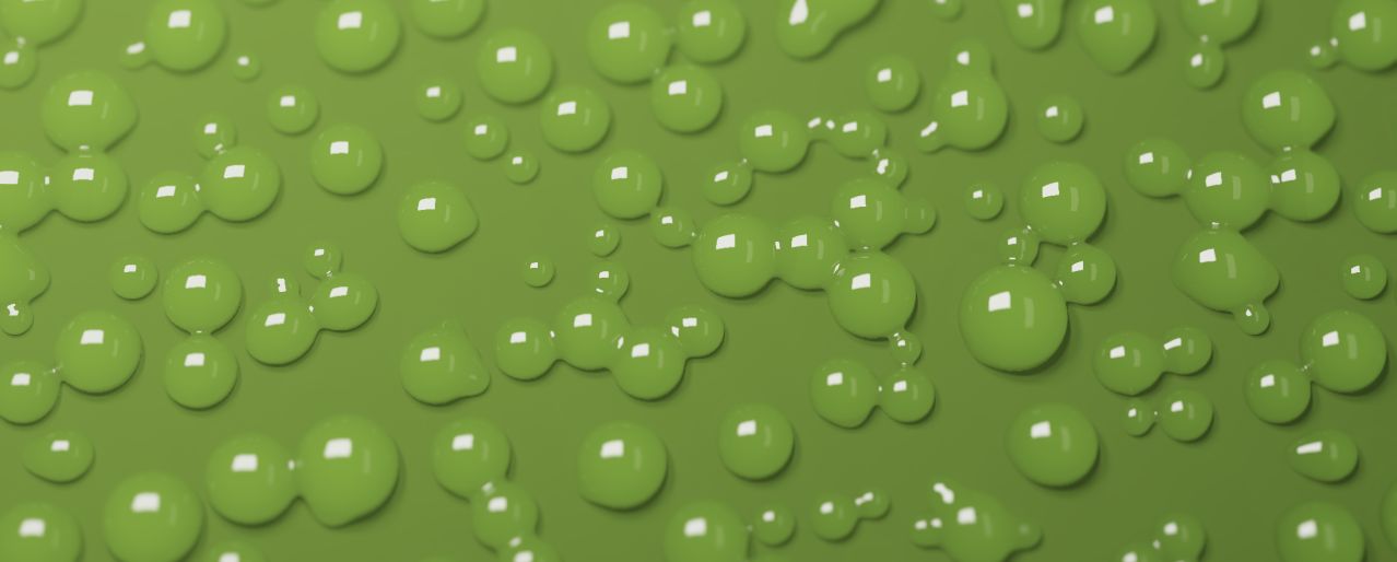 Luminous green water droplets gathering on a pale surface, captured from Undra.